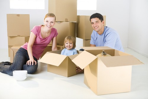 Professional movers handling furniture on a residential street
