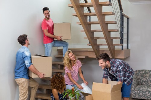 Movers handling household items in a flat near Aldboroughhatch