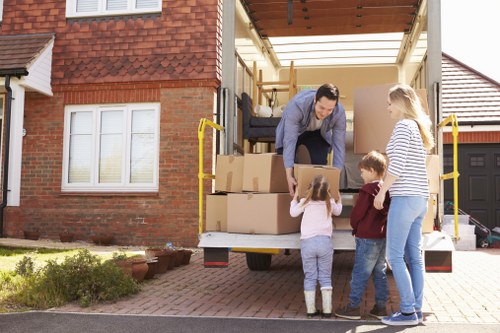 Packed boxes and furniture ready for transport by movers