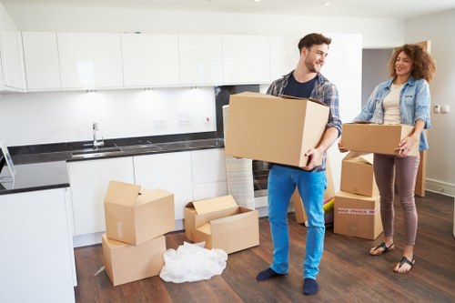 Packed moving boxes and removal equipment ready for house relocation