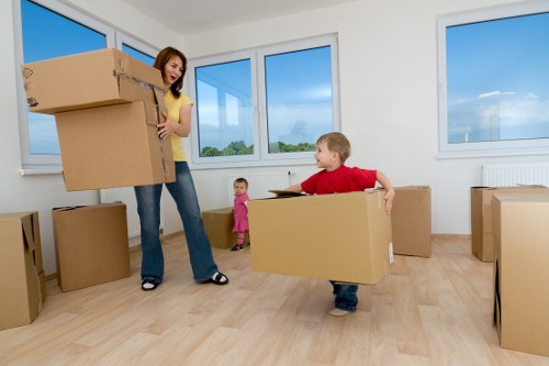 Mover loading household furniture for an Aldboroughhatch removal service