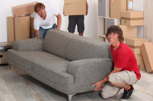Removal crew handling desks and IT items during an office move